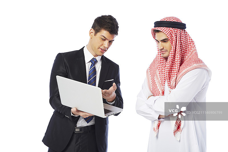 穿着西装的男人和戴着坎杜拉的男人看着监视器的影棚照图片素材