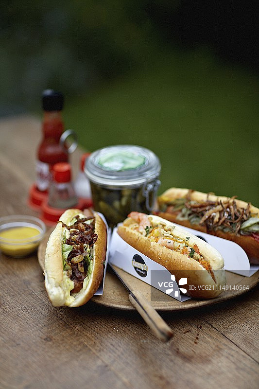野餐桌上的三个不同的热狗图片素材