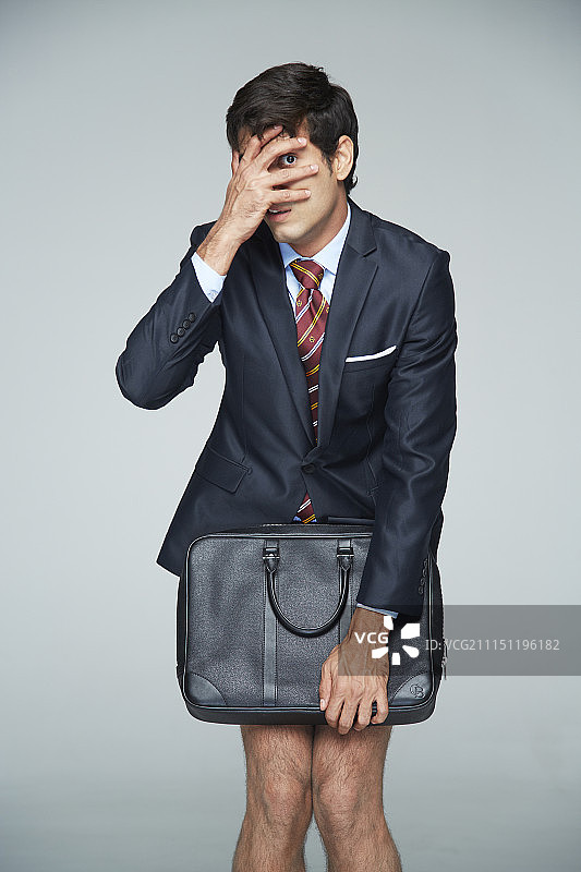 没穿裤子，害羞地遮住裤子的商人照片图片素材