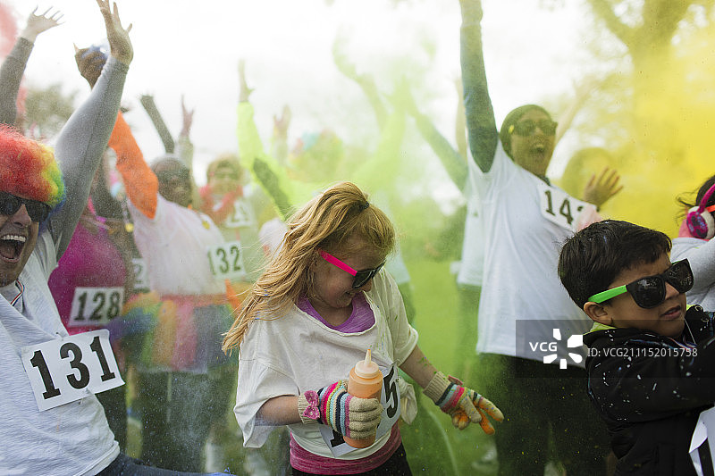 慈善跑中投掷彩色粉末的欢乐人群图片素材