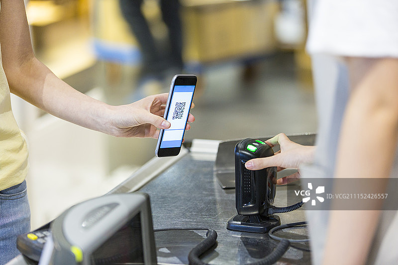 年轻女子在超市收银台付款手部特写图片素材