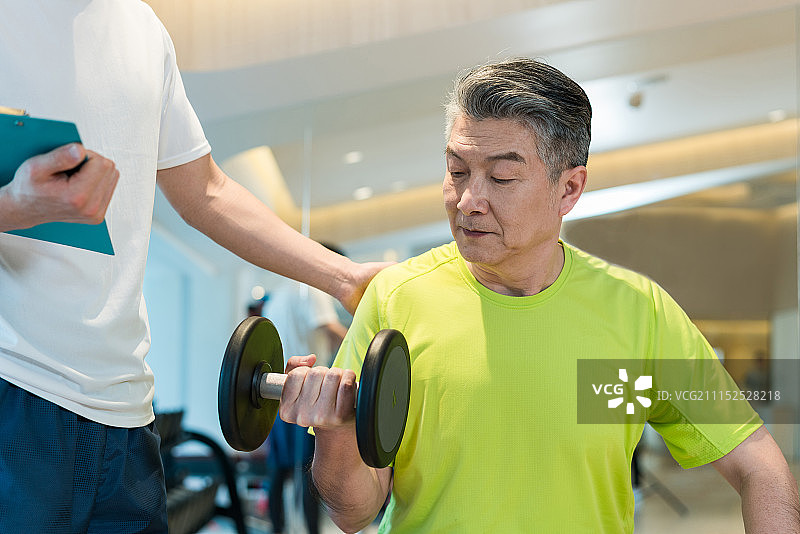 老年男子在私教的指导下健身图片素材