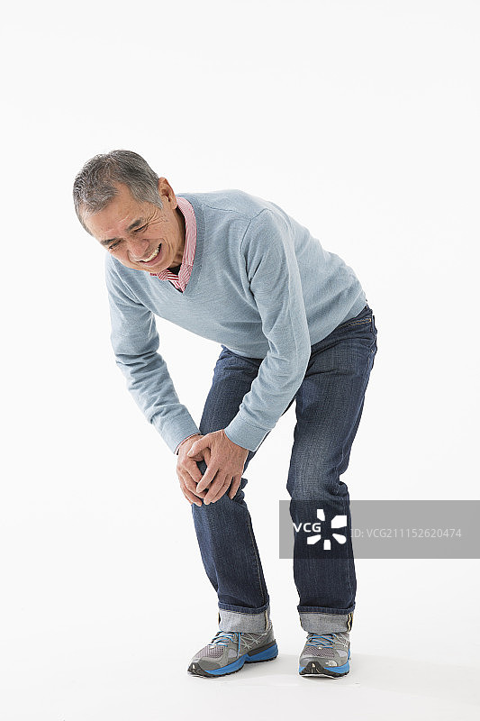 一位患有膝盖疼痛的年长男人图片素材