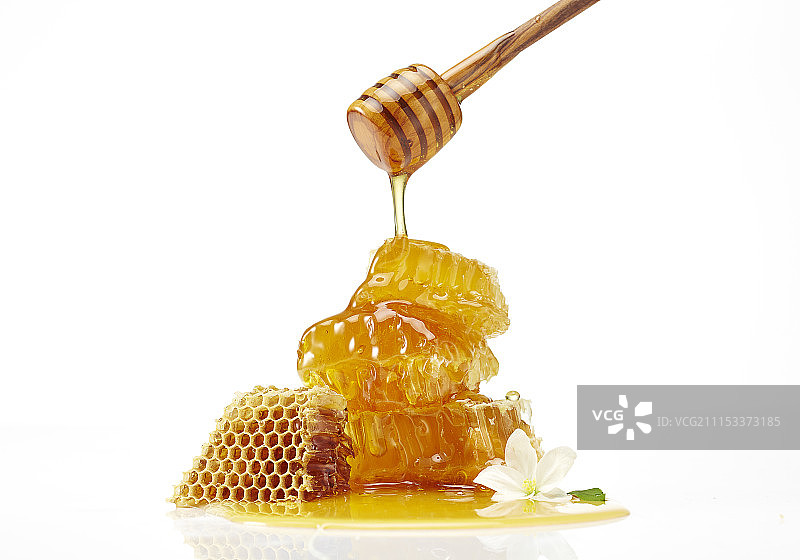 蜂窝和蜂蜜勺摄影图片素材