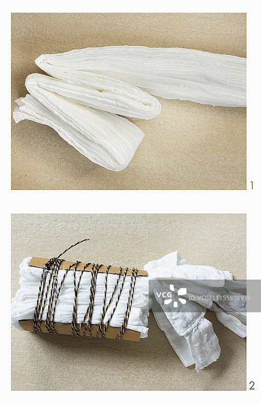 使用扎染技术准备窗帘染色：用厚纸板固定并用绳子包裹图片素材