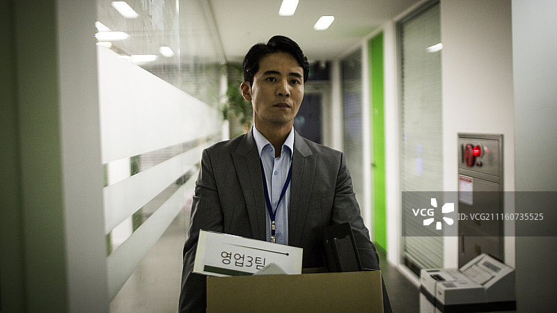 拿着箱子辞职行走的商务人士摄影图片素材
