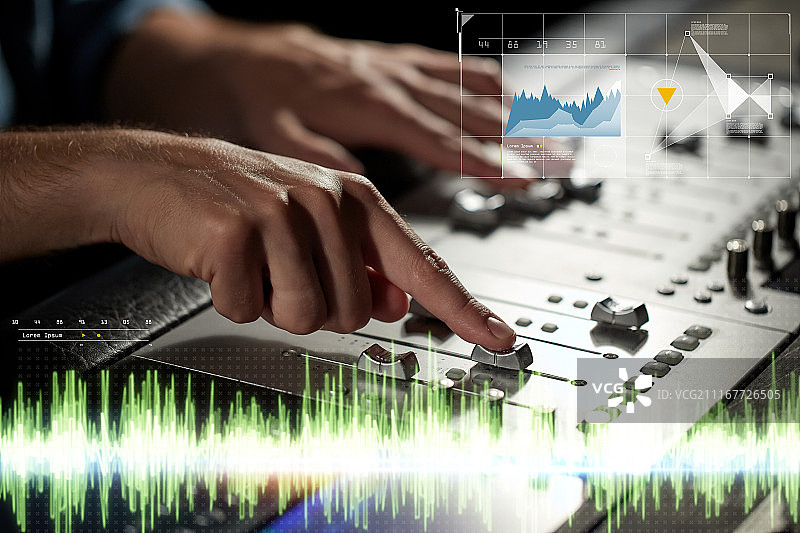 录音棚里使用调音台的双手图片素材