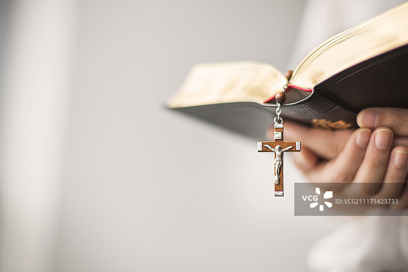 手持圣经和天主教物品摄影图片素材