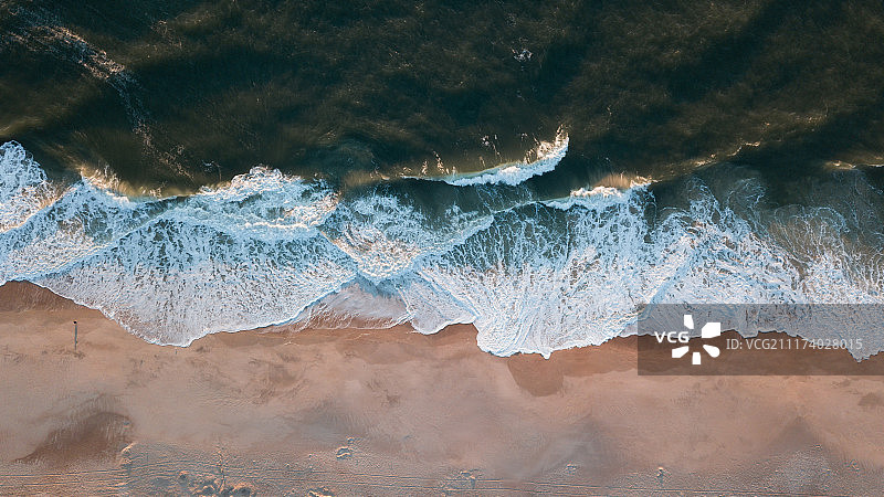 日出时海滩上的波浪图片素材