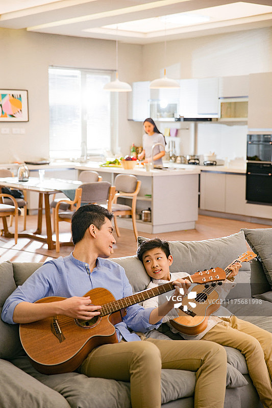 父亲和男孩在弹吉他图片素材