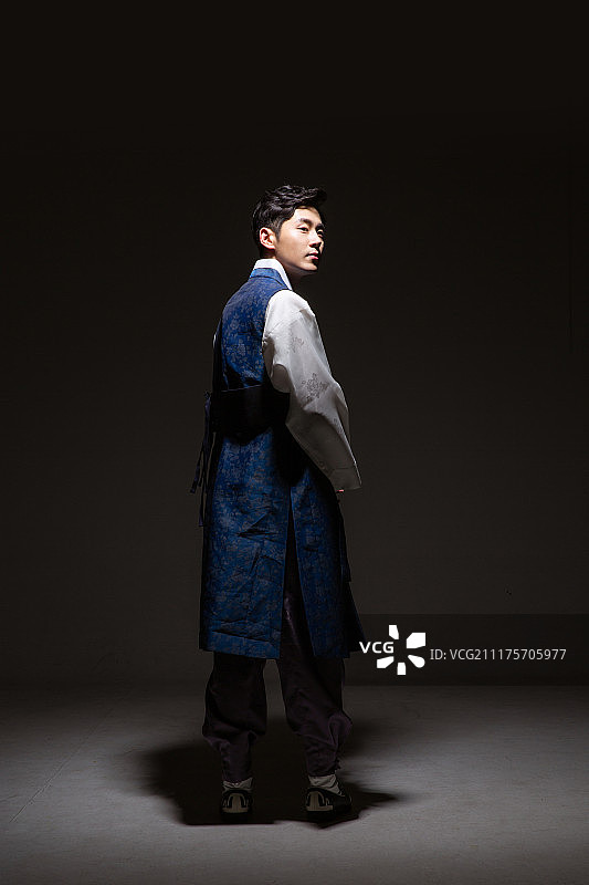 穿着韩服的韩国男子背影，黑暗中的光线图片素材