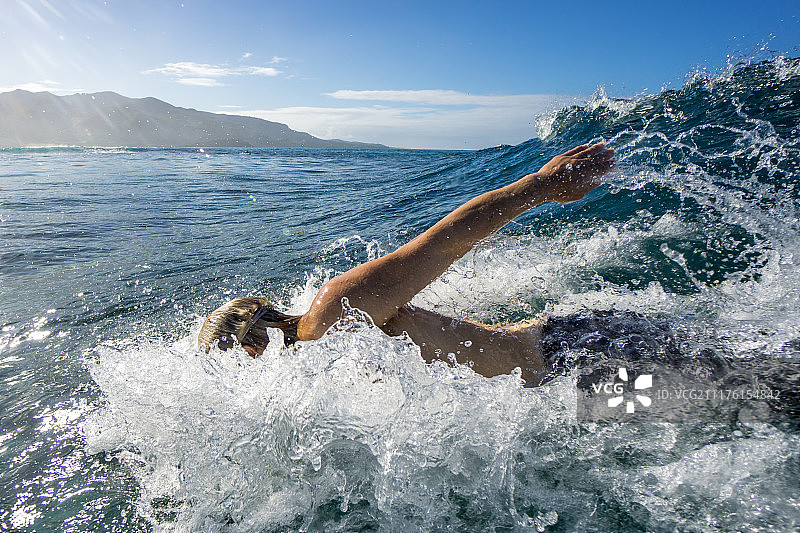 在毛里求斯海浪中游泳的冲浪者图片素材
