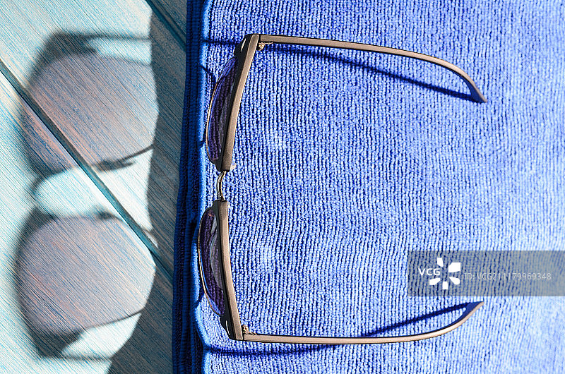 桌上的时尚太阳镜和毛巾图片素材