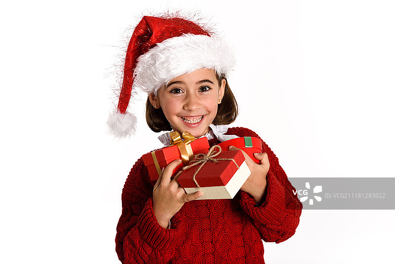 戴圣诞帽的小女孩携带许多圣诞礼物盒图片素材