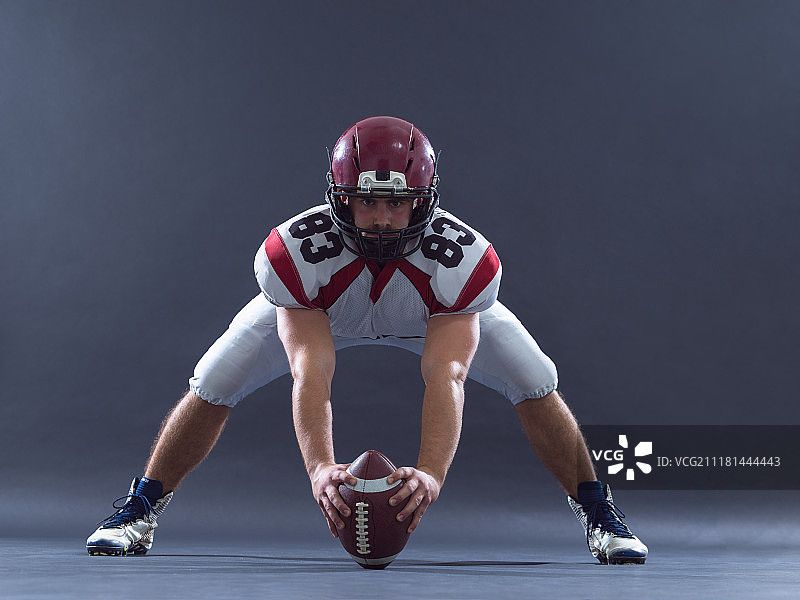 在灰色背景下准备比赛的橄榄球运动员图片素材