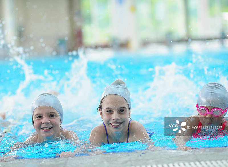 在游泳池学习游泳的快乐儿童图片素材