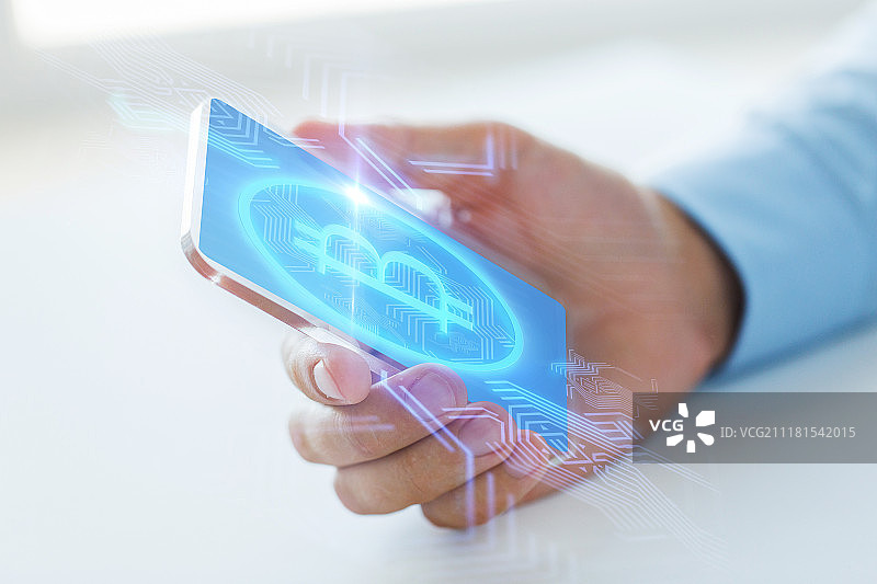 商务、科技与加密货币概念：男性手持透明手机展示比特币图片素材