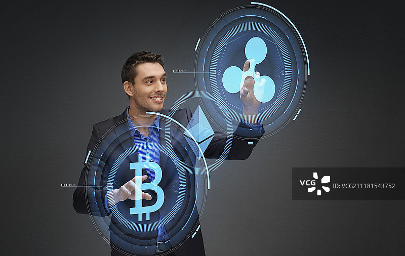 加密货币、金融科技和商业概念——微笑的商人使用比特币、以太坊和瑞波币全息图图片素材