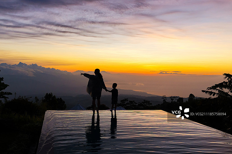 印度尼西亚无边泳池上的人物剪影图片素材