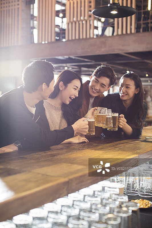 快乐的朋友们在酒吧喝酒干杯图片素材