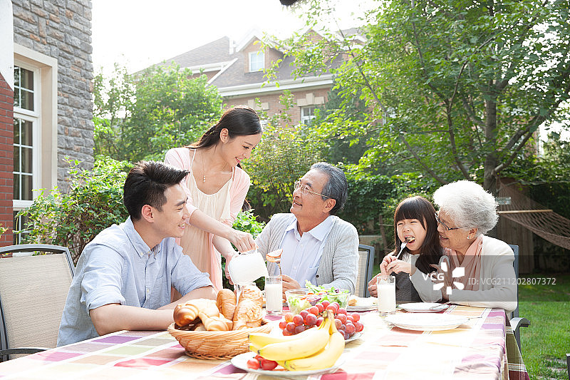 快乐家庭在户外吃早餐图片素材