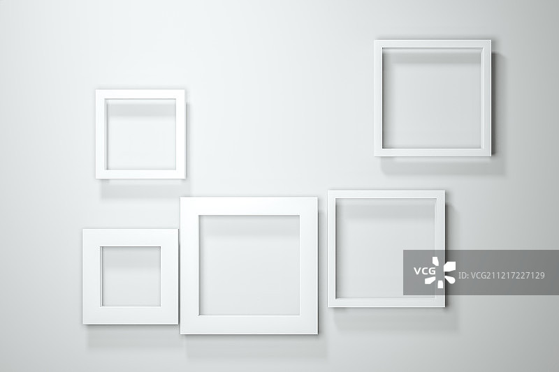 白色墙壁上排列布置的白色相框图片素材