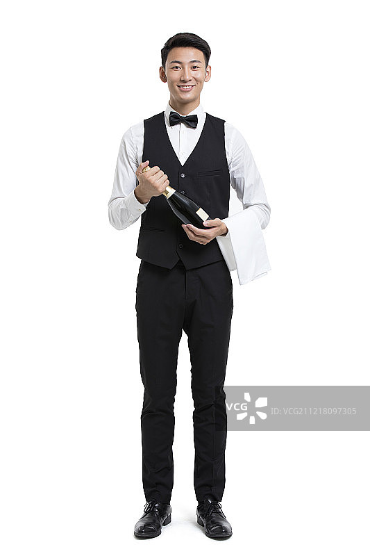 年轻服务员拿着一瓶香槟图片素材