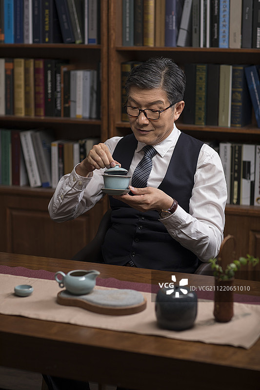 成功商务男士在书房品茶图片素材