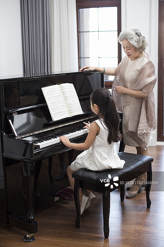 小女孩为奶奶弹钢琴图片素材