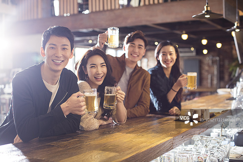 快乐的朋友们在酒吧喝酒干杯图片素材