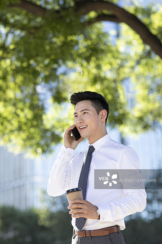自信的年轻商务男士打电话图片素材