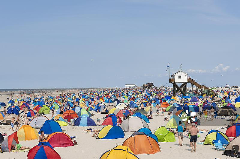 德国石勒苏益格-荷尔斯泰因州圣彼得奥尔丁海滩上挤满了带沙滩帐篷的游泳者图片素材
