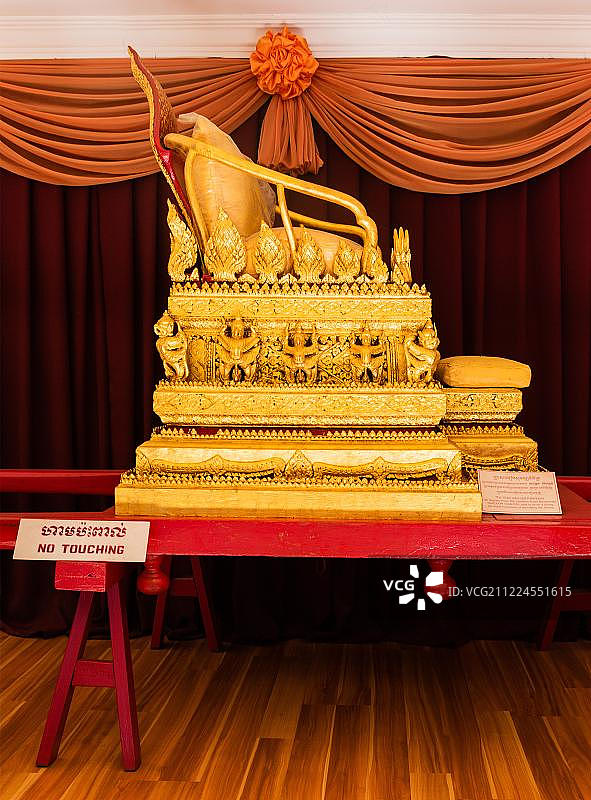 柬埔寨金边王宫入口亭展览空间内的金色装饰轿子图片素材