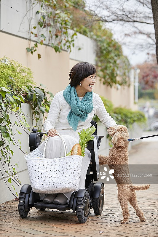乘坐电动轮椅的日本老年妇女图片素材