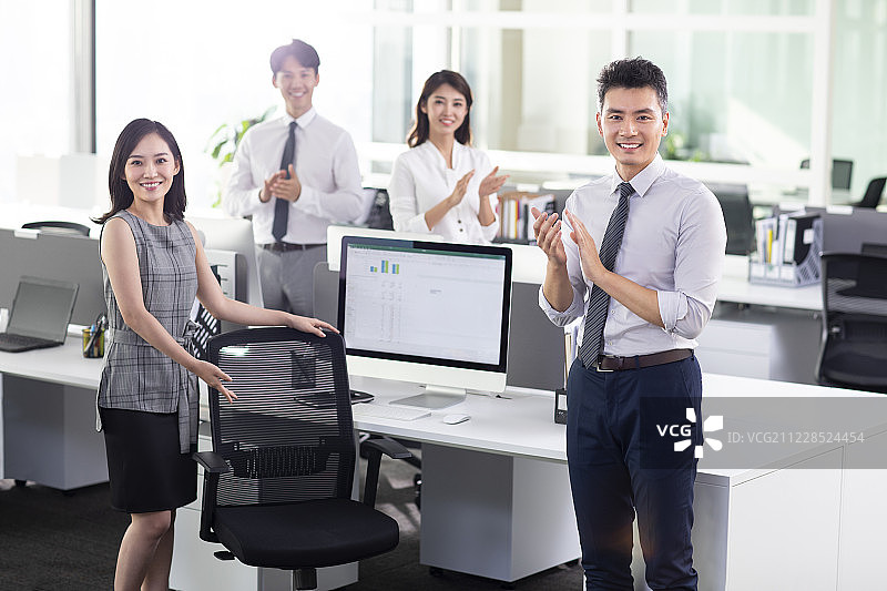 成功商务人士在办公室鼓掌庆祝图片素材