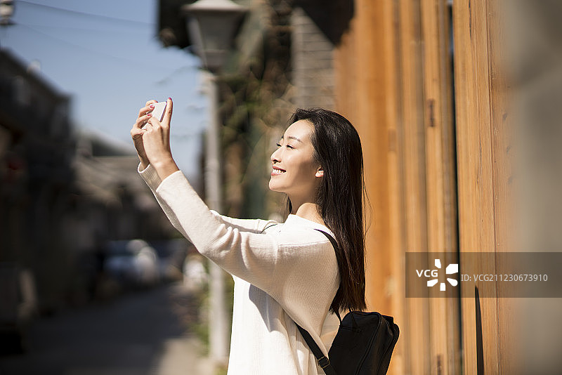 年轻女子用手机拍照图片素材