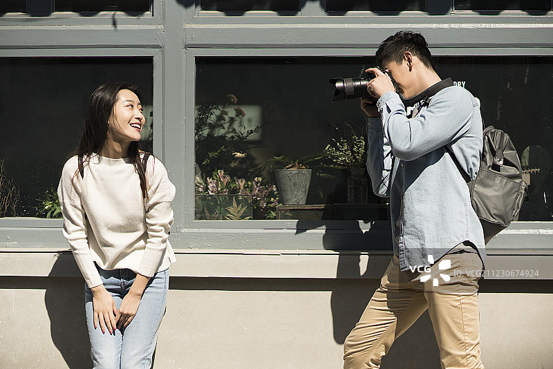 年轻情侣在北京胡同拍照图片素材