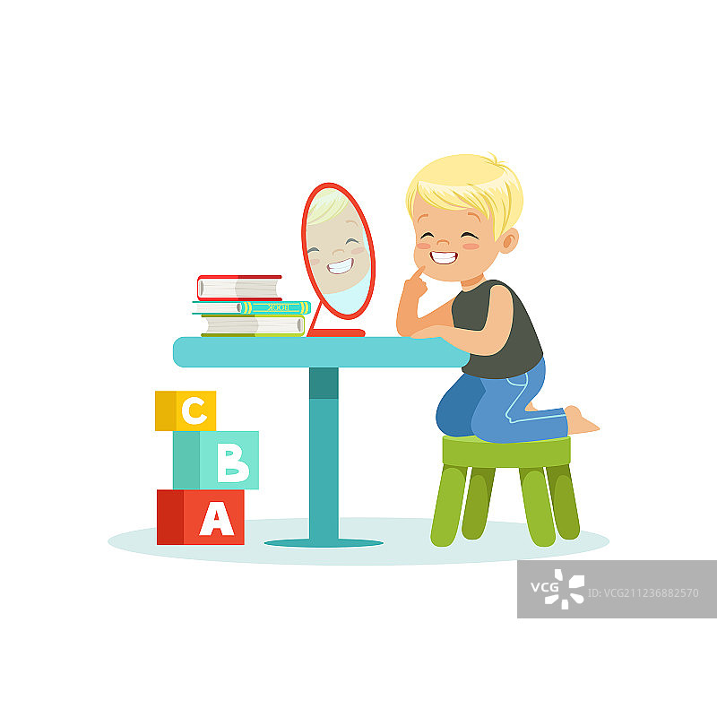 坐在桌旁观看的可爱小男孩图片素材