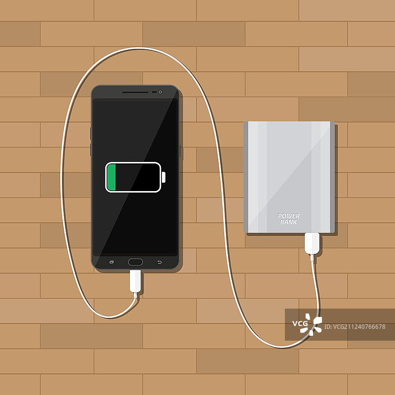 在木桌上用充电宝给智能手机充电图片素材