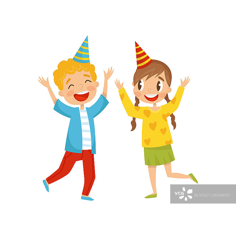 戴派对帽的可爱女孩和男孩玩得很开心图片素材