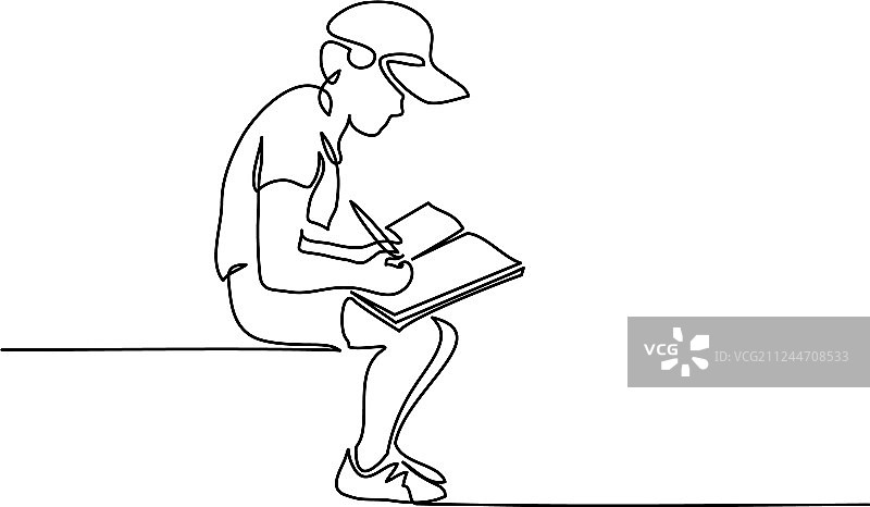 男学生坐着用铅笔在书上写字图片素材