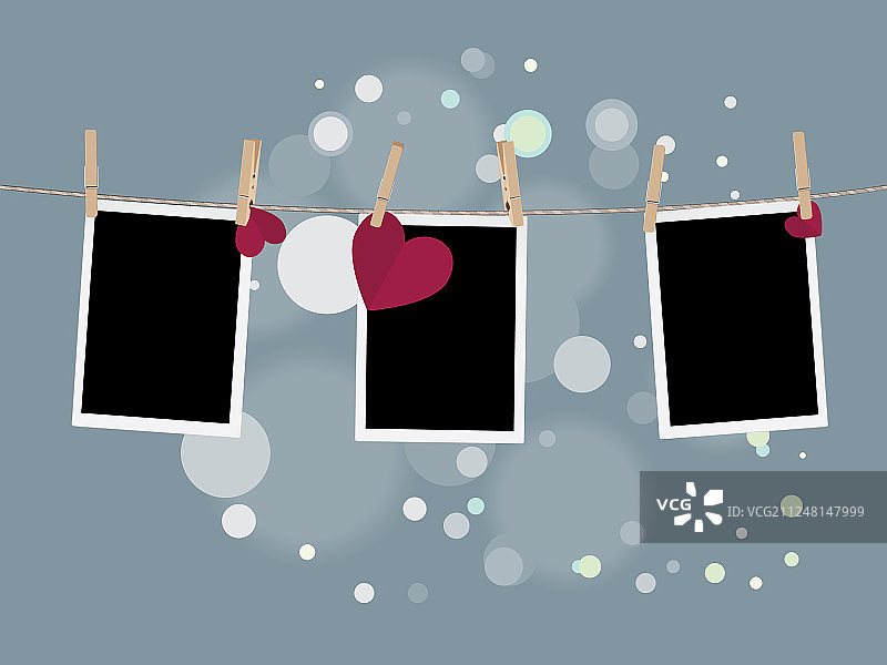绳子上的带胶片框的爱心图片素材