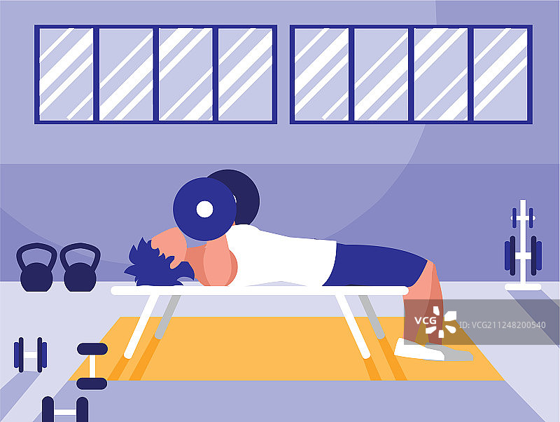 年轻男人在健身房举哑铃图片素材