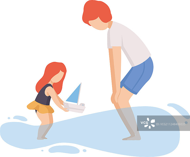 父女在海滩上玩玩具船图片素材