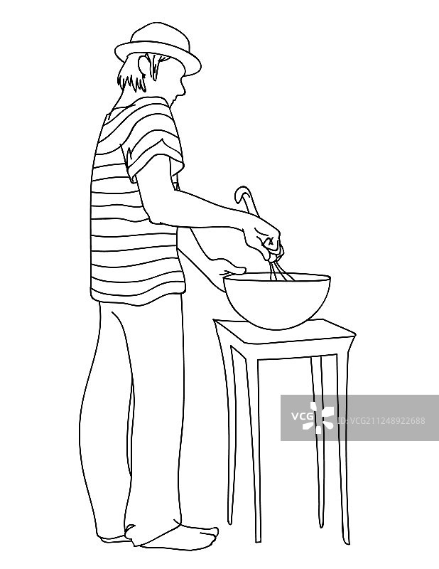 戴帽子、穿条纹T恤的年轻男人在准备食物图片素材