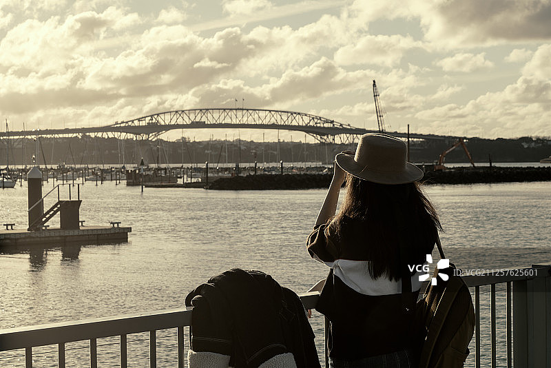 以为女性游客看向远处旅行景点日落时分图片素材