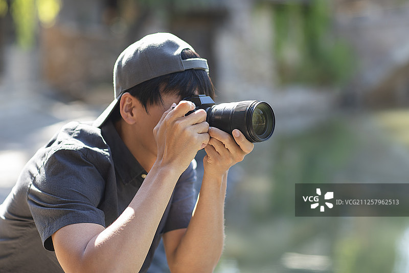 年轻摄影师使用相机摄影图片素材
