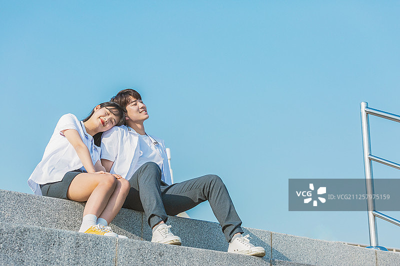 高中生校服微笑，校园情侣楼梯对话图片素材