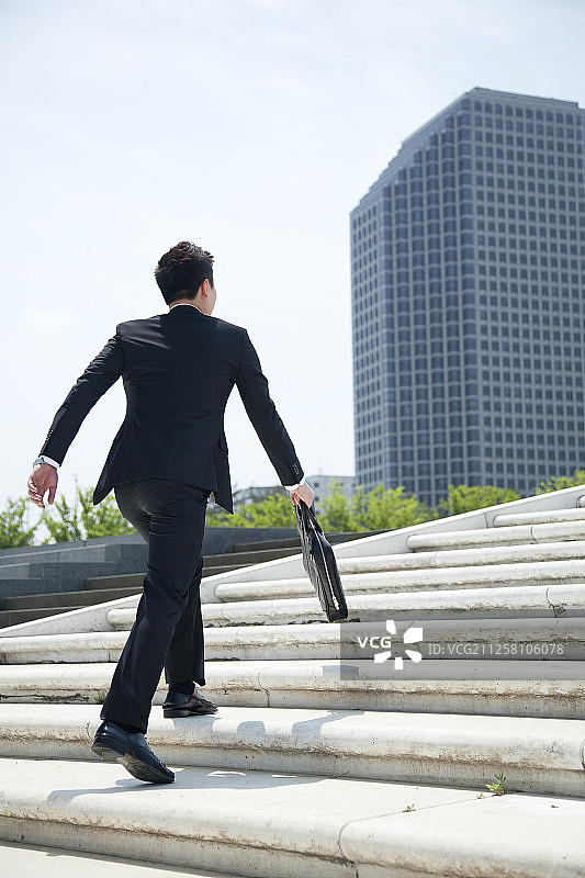 在室外楼梯上奔跑的商人摄影图片素材