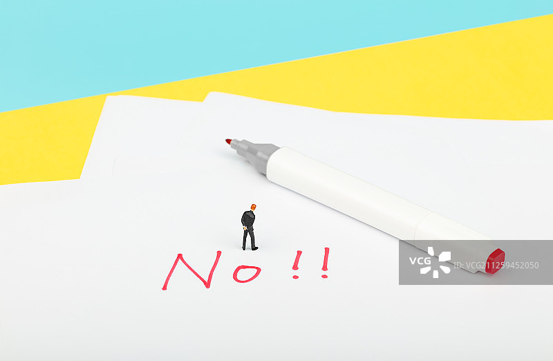 西装男性站在红色的No旁思考图片素材